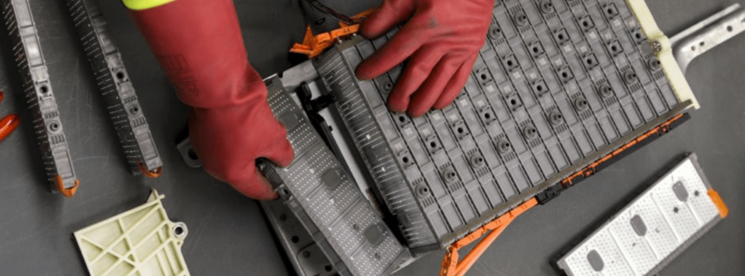 Man in PPE dismantling lithium-ion battery - FUTURE PROVENANCE OF BATTERY MINERALS - Black Mass